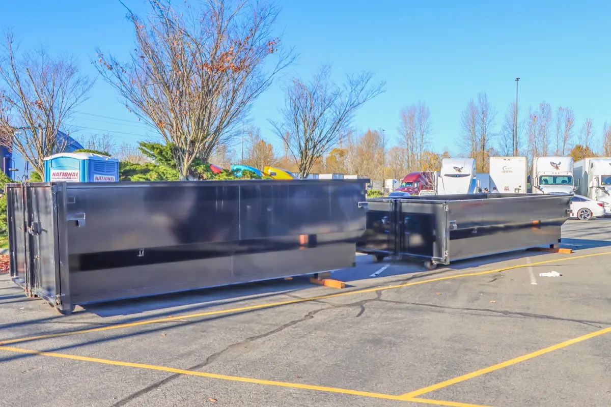 Professional dumpster rental service with roll-off container on residential driveway in Haddam